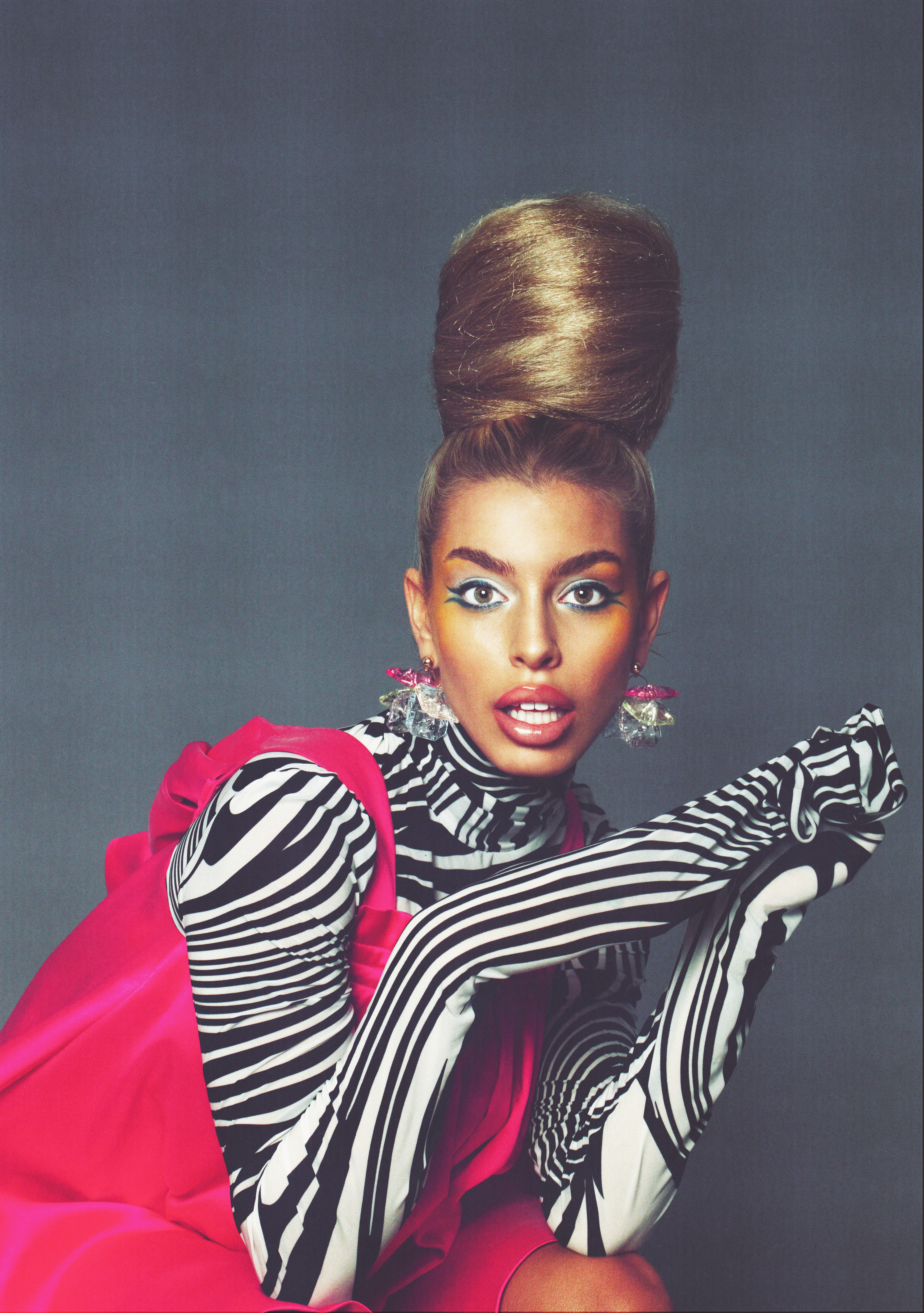 Bold creative direction with dramatic beehive updo and high-fashion styling